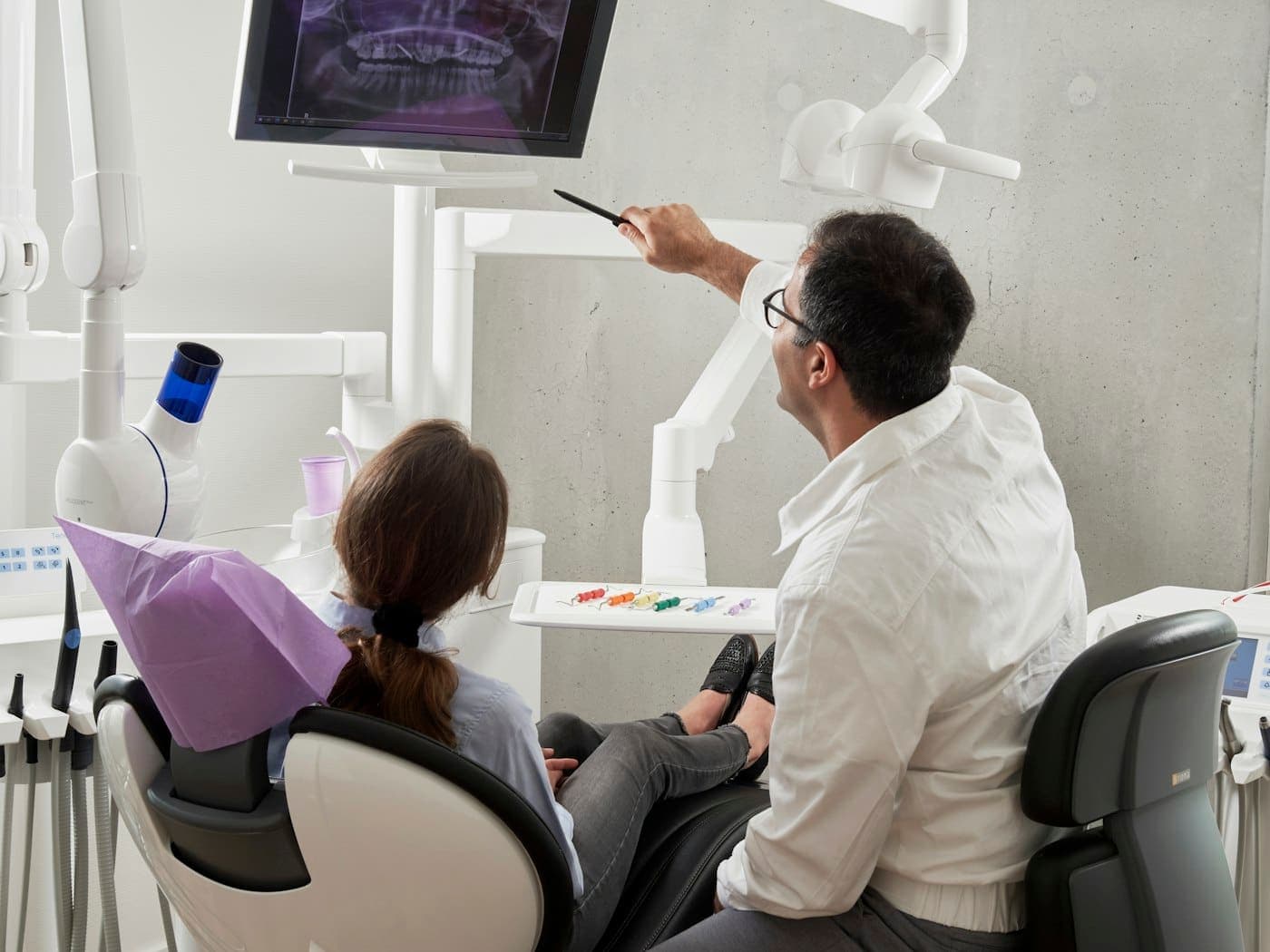 A dentist working chairside with a patient